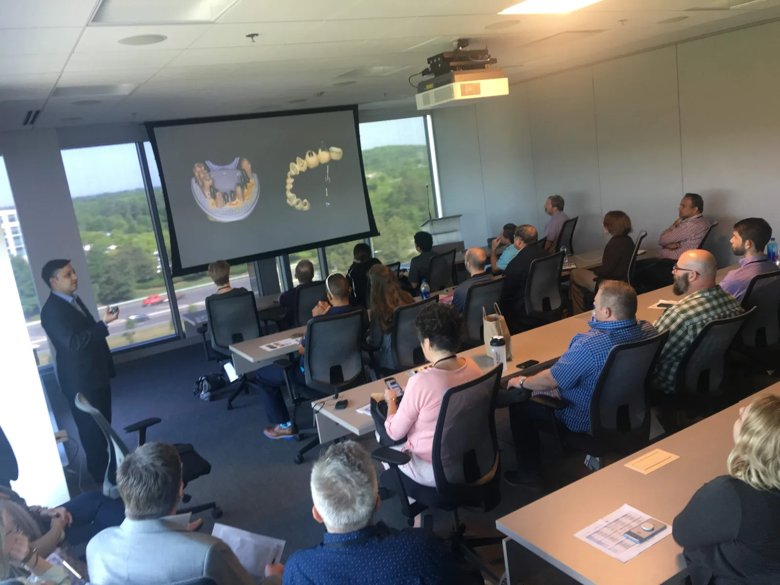 Dr. Kunal Lal presenting digital implant workflows to an audience of dentists at the Dentsply Sirona meeting in North Carolina