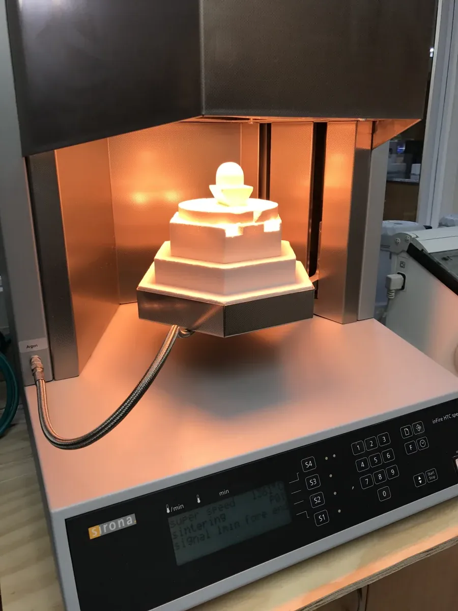 Zirconia restorations glowing inside the porcelain furnace