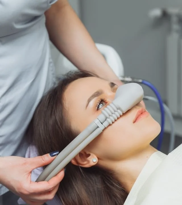 A patient breathing nitrous oxide through a nasal mask in the dental chair